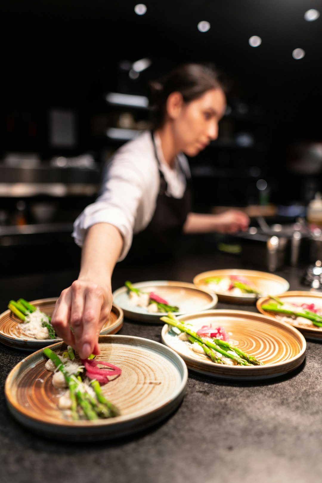 person-in-white-shirt-slicing-vegetable-jjib2e7jkcs