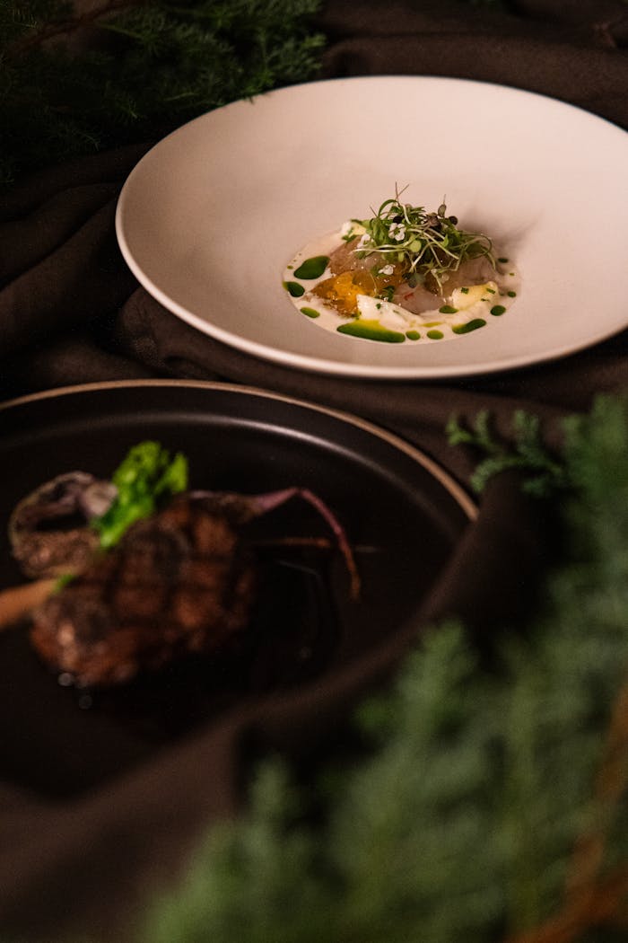 Close-up of elegantly plated fine dining dishes at a Tokyo restaurant, showcasing culinary artistry.